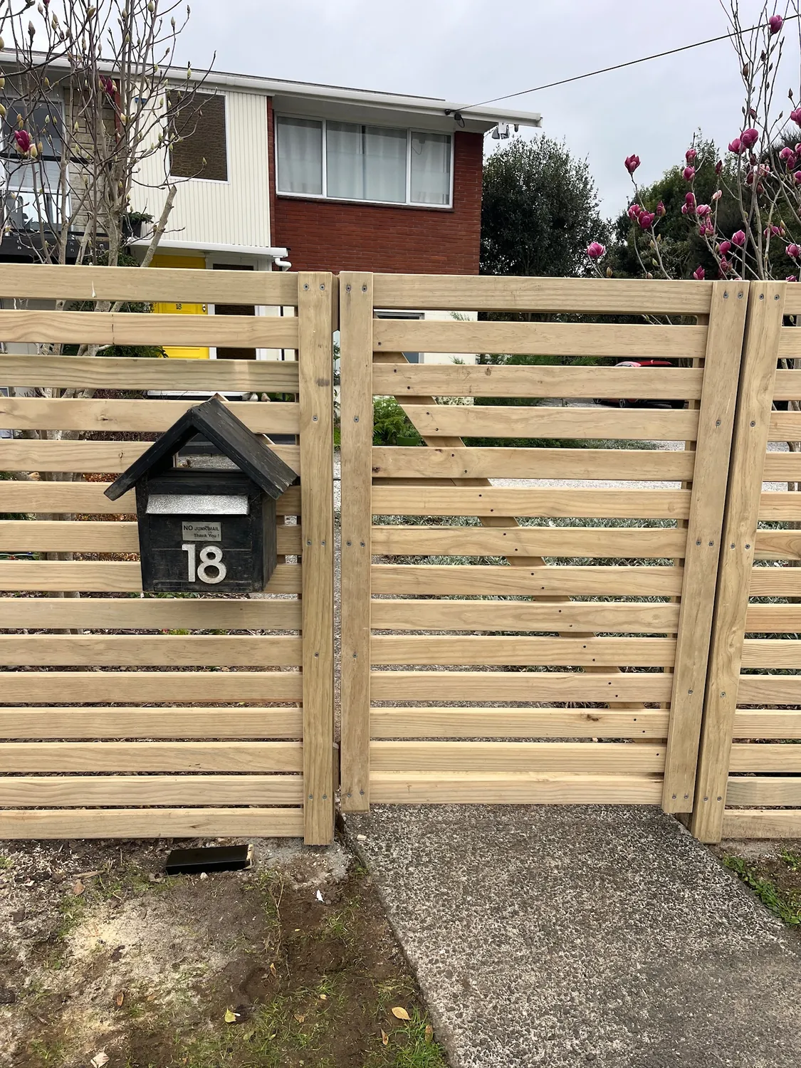 Horizontal slat timber fence and gate built in Hamilton